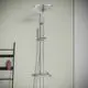 Duschsystem von Ideal Standard mit Kopfbrause und Handbrause. Montiert an einer Wand, mit einem Thermostat und zwei Drehreglern zur Temperatur- und Wassermengenregulierung.